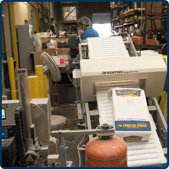 Packaged Langlois product on a conveyer belt