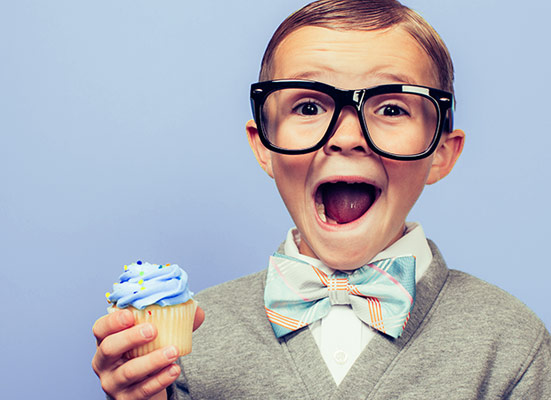 Boy extremely happy about the cupcake in his hand